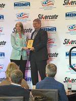 Mark Detwiler, principal engineer within Cornerstone Building Brands’ Metal Solutions business, accepts recognition for his induction into the 2026 Metal Construction News Hall of Fame from Melanie Kowal of Kenilworth Media.