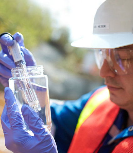 Photo of Hudbay employee testing water