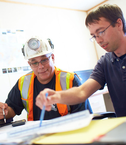 Photo of two Hudbay employees going over notes