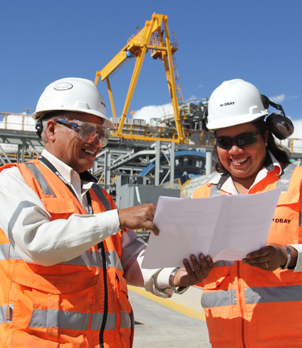 Photo of two Hudbay employees reading on site