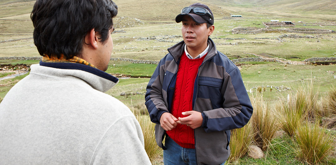 Two employees in a field near a Hudbay mine site