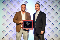 Matt Carlquist, director of Safety & Health (L) and Ron Bridgewater, vice president of System Integrity, accept the award at the AGA 2025 Operations Conference on May 6 .