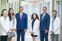 Sam Hazen, CEO of HCA Healthcare, and Dr. Anderson Spickard, Dean of the Thomas F. Frist, Jr. College of Medicine at Belmont University, stand with medical students at HCA Healthcare’s TriStar Centennial Medical Center.
